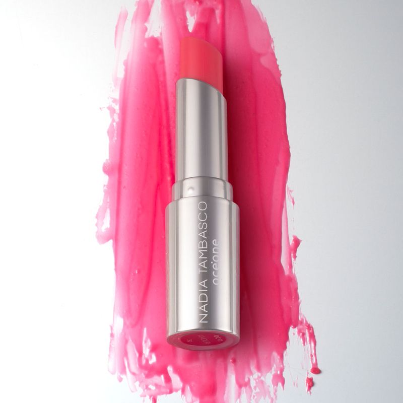 Revitalizador Labial Rosa Pink Nádia Tambasco By Océane Sweet Lips Amour, embalagem aberta frete com textura ao fundo